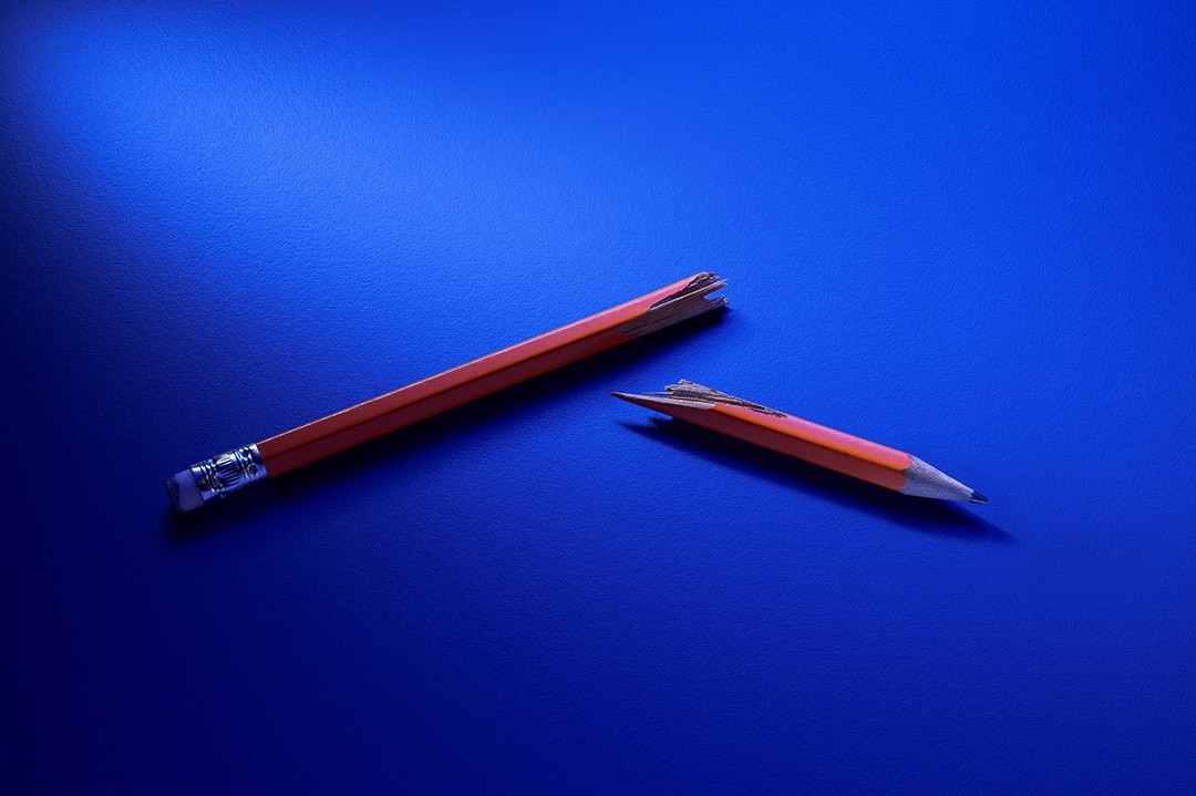 Ford Money zerbrochener Bleistift auf blauem Hintergrund